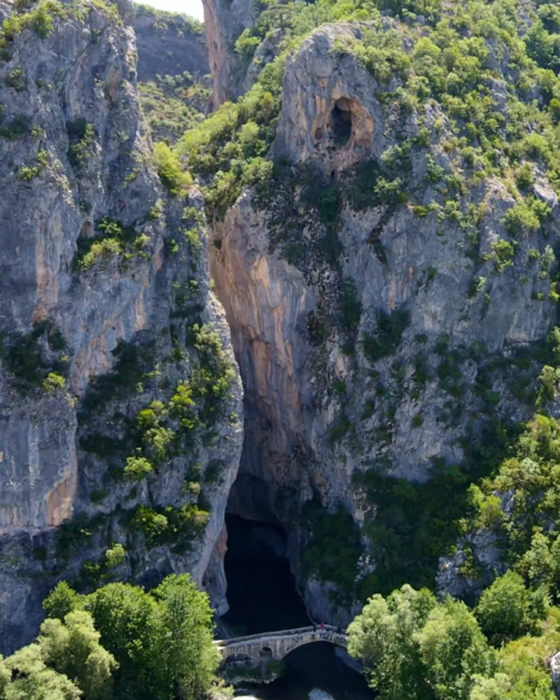 A scenic view of a canyon with a bridge in Leskovik Albania