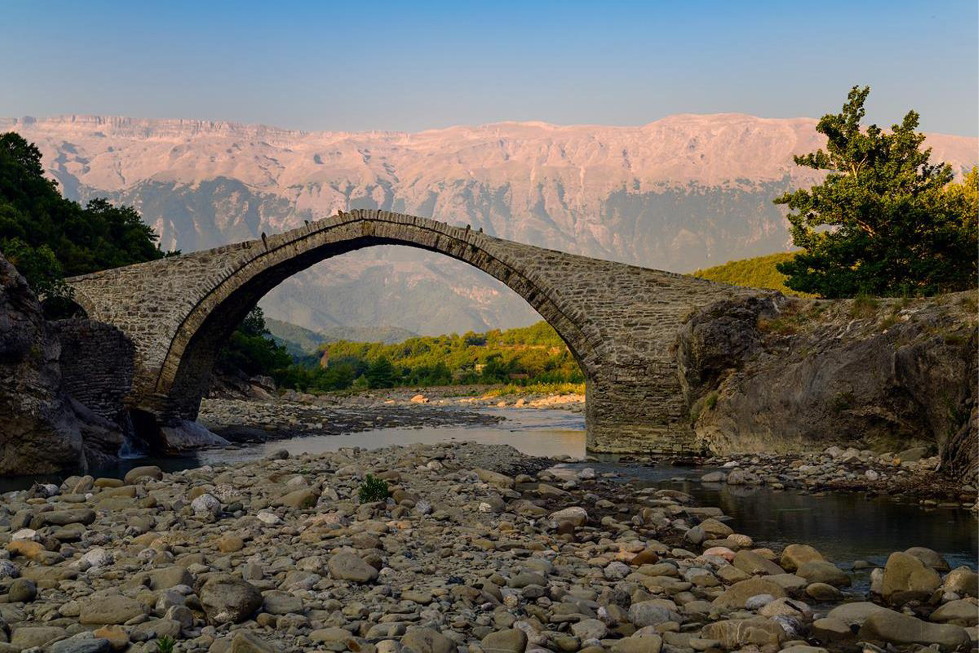 The beautiful Kadiut Bridge, Benje, Permet in Southern Albania with stunning mountains in the background